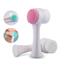 White facial cleansing brush with pink and green accents on a white background