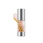 Skincare serum bottle with colorful droplets on a white background