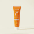Orange tube of Blesso Vitamin C brightening cleanser on a beige background