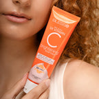 Person holding a tube of Blesso Skin Active 5X Vitamin C brightening facial foam.