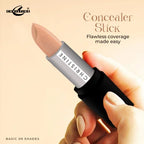 Concealer stick held by a hand with a beige background, featuring the brand 'Christine'.