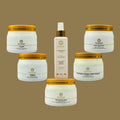 Collection of skincare products with gold lids on a brown background