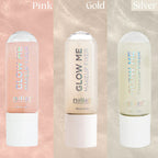 Three bottles of 'Glow Me' makeup fixer in pink, gold, and silver on a gradient background.