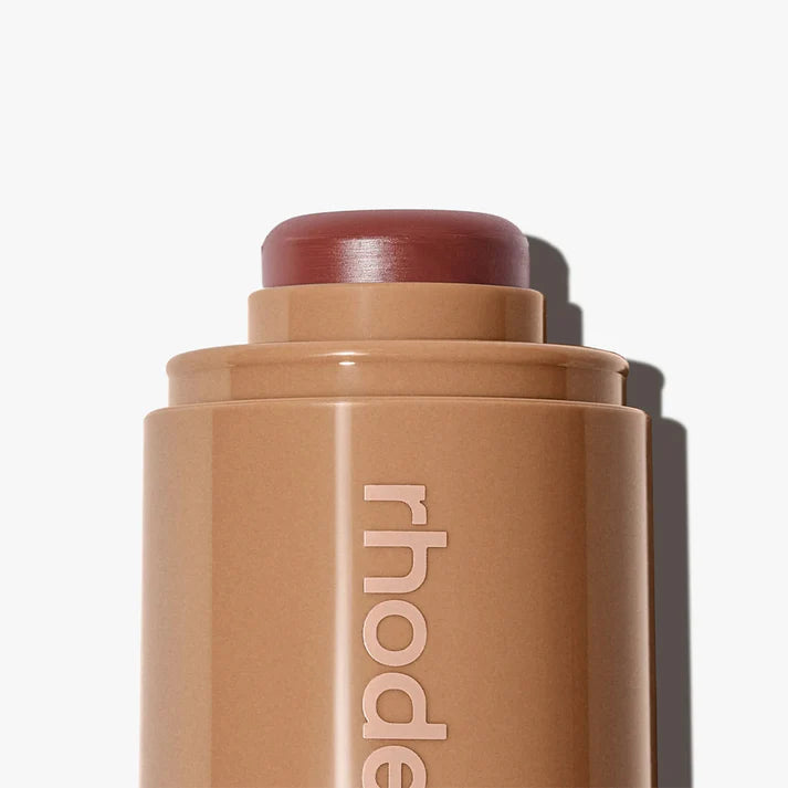 Cosmetic stick with 'rhode' branding on a white background