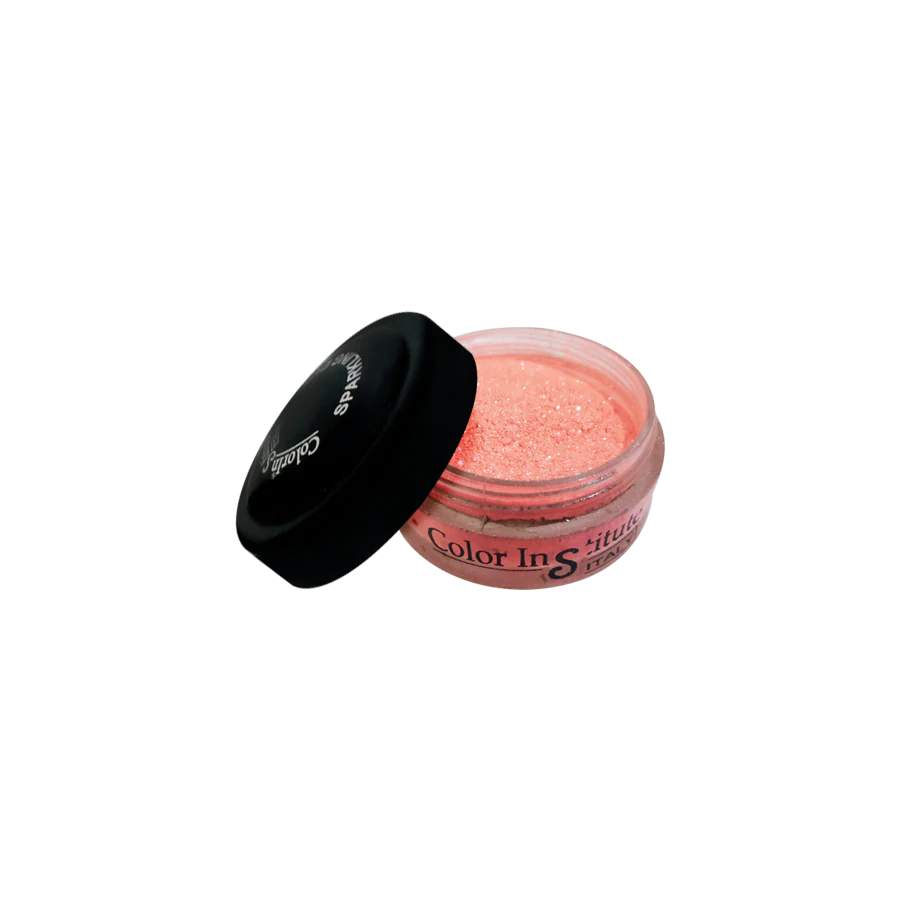 Open jar of pink glitter with black lid on a white background